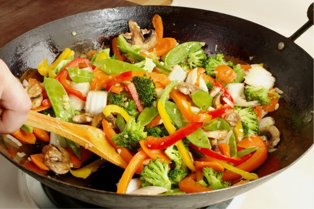 Asian-style stir-fry vegetables cooking in a wok